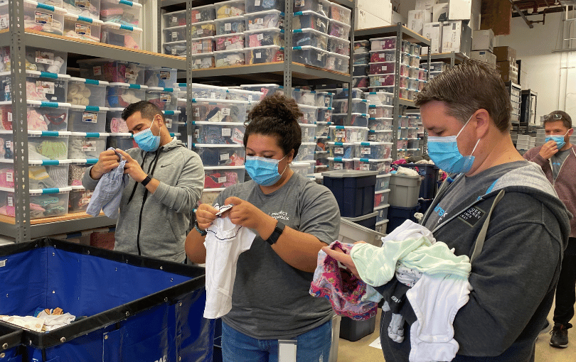 Volunteers sorting clothing donations.