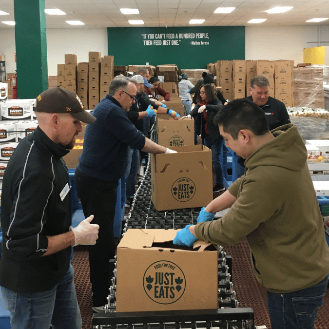 Volunteers packing meal boxes at Food for Free.
